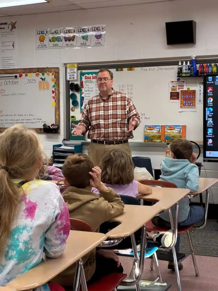 Image shows Grady Wilson, Library Director, speaking to a classroom of children.