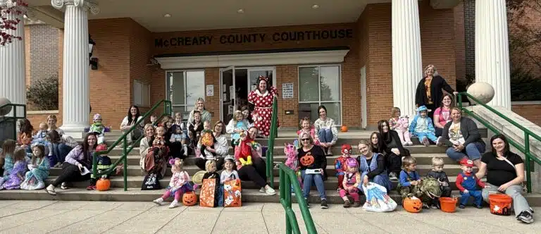 Group of Kids and adults in Halloween costumes on courthouse steps