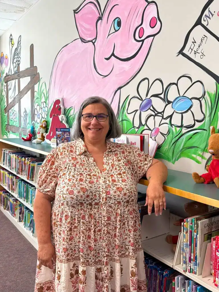 Photo of Tammy Neal standing in the children's area a the library.