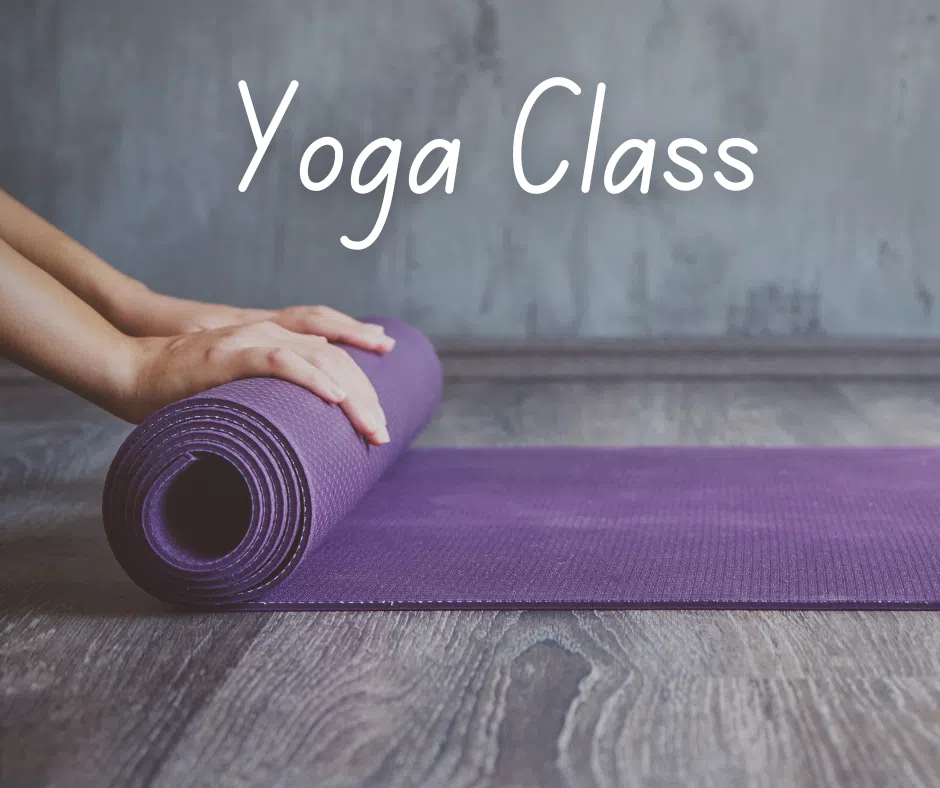 A person unrolling a yoga mat, with text Yoga Class