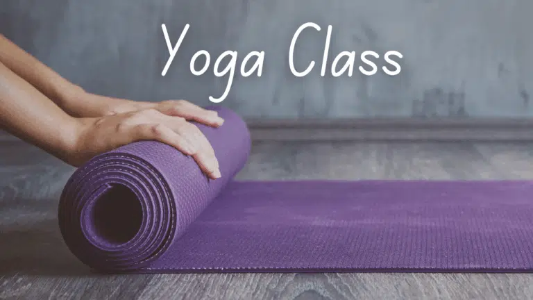 Shows a hand rolling up a yoga mat. White text says Yoga Class.